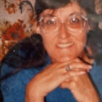 Becky Schlief smiling, wearing glasses
